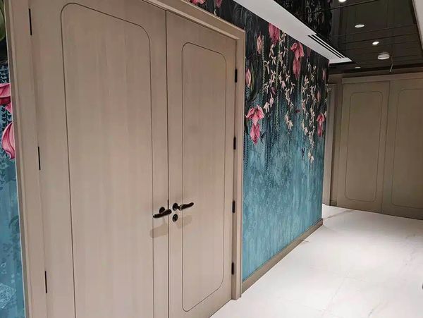 Feature wallpaper and professionally painted doors in a commercial interior in Worcester.