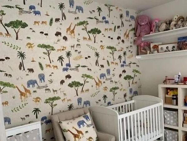 Wallpaper hanging in a children’s room with patterned wallpaper and a neatly finished feature wall