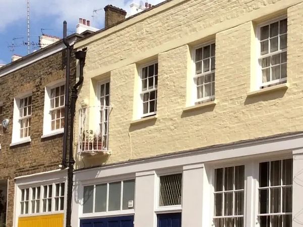 Freshly painted period townhouse exterior with yellow painted brickwork