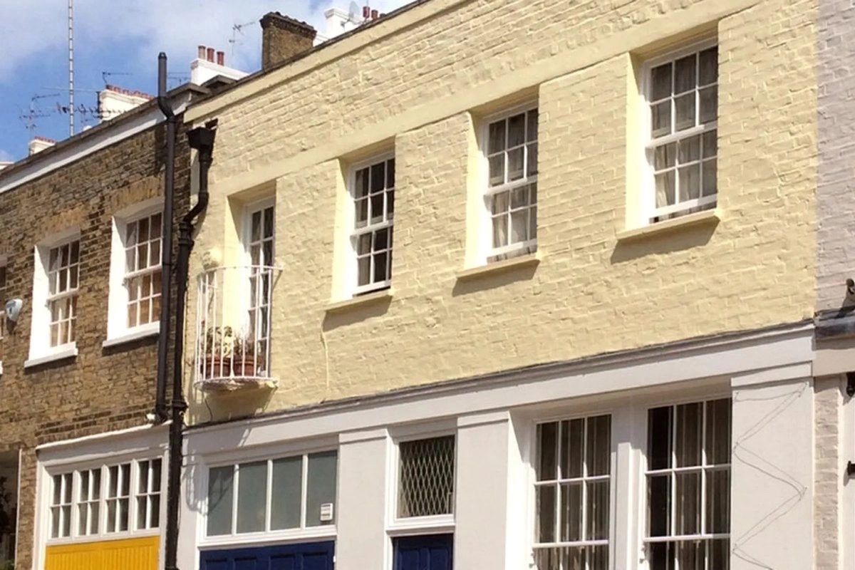Front of a terraced property painted yellow brickwork