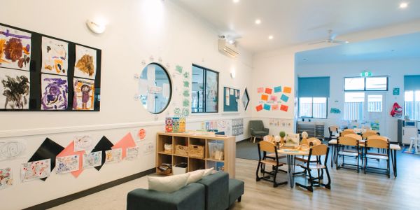 Bright and colorful early childhood classroom with children's artwork on walls.