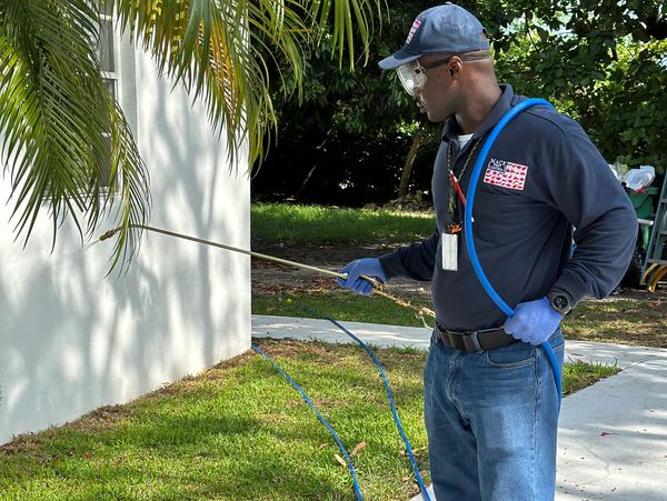 Owner, Kevin Mack applying insecticide placing a barrier that will keep pest from entering the home.