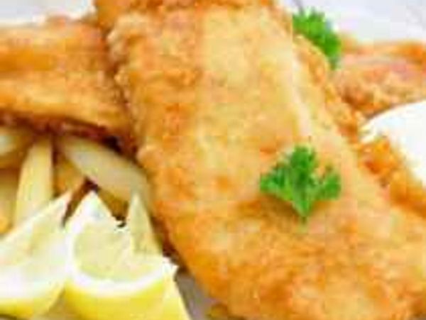 Crispy fried fish fillet with lemon wedges and parsley garnish.