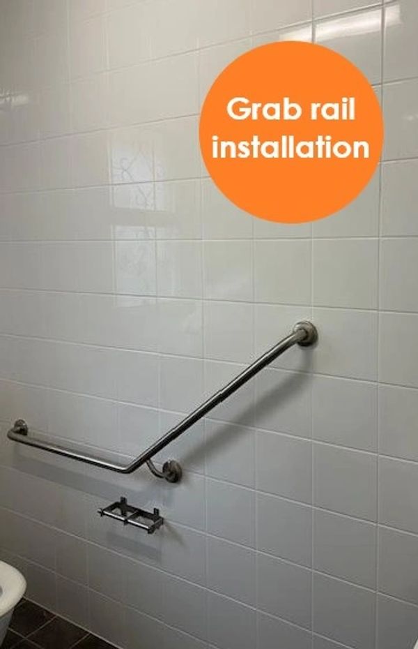 Grab rail installed on bathroom wall.