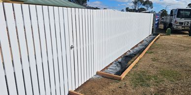 Beautiful white timber picket fence, installed with steel frame. Landscape and fencing design