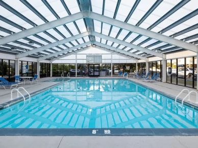 Indoor swimming pool with a glass roof.