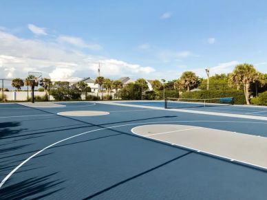 Empty outdoor sport court with blue and gray flooring.