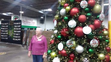 Marcil standing beside the Christmas tree @ Samaritan's Purse "Operation Christmas Child"