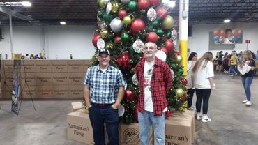Nathan Leatherwood and Jason Killian in front of the Christmas tree @ Samaritan's Purse "Operation