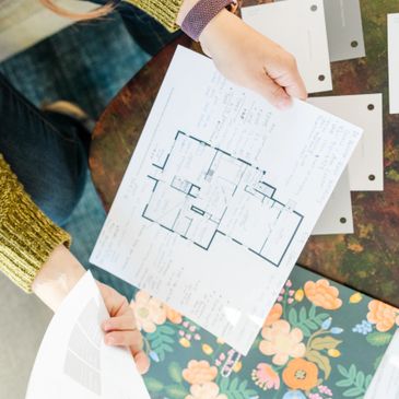 Jessica Gaucher looking at a floor plan to work on a space planning project