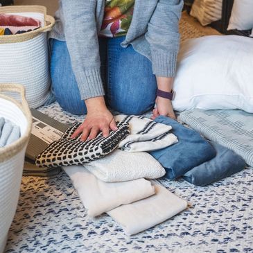 Jessica Gaucher selecting pillow covers for a home staging project
