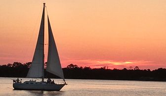 Sunset sailing in Orange Beach, Alabama with Back Bay Sailing Adventures. Best boat tour Gulf Shores