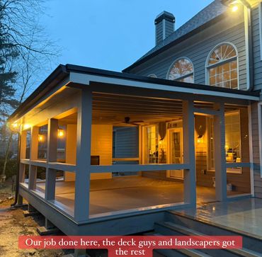 Newly built covered deck illuminated warmly at dusk.