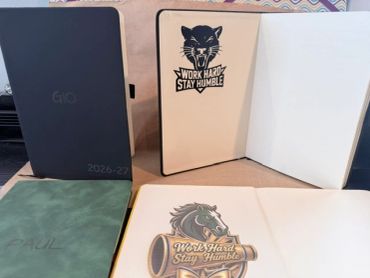 Customized notebooks with motivational quotes inside cover.