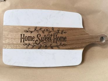 Decorative cutting board with "Home Sweet Home" engraving.