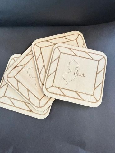 Wooden square coasters with state outline and 'Brick' text.