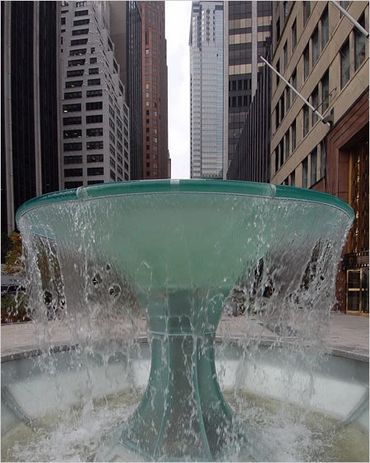 Water fountain flowing in an urban cityscape.