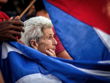 Havana Nov 30, 2016: An elderly woman watches Fidel Castro's ashes pass by.
