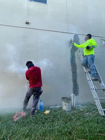 Two stucco plaster workers