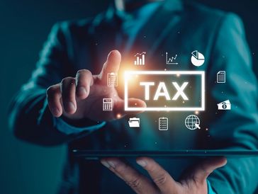 Businessman show TAX for Individual income tax return form online for tax payment concept