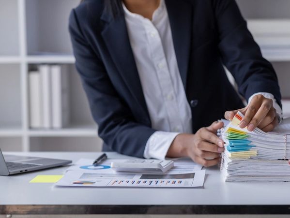 Business Employee Asian woman hand working in Stacks paper files for searching