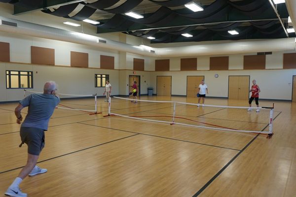 pickleball players are seen vollying the pickleball during a game in the Rec Room at ARC