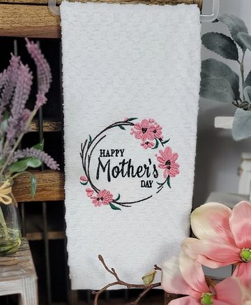 White towel with embroidered pink flowers and 'Happy Mother's Day' text.