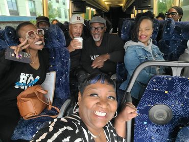 Group of friends smiling on a bus.