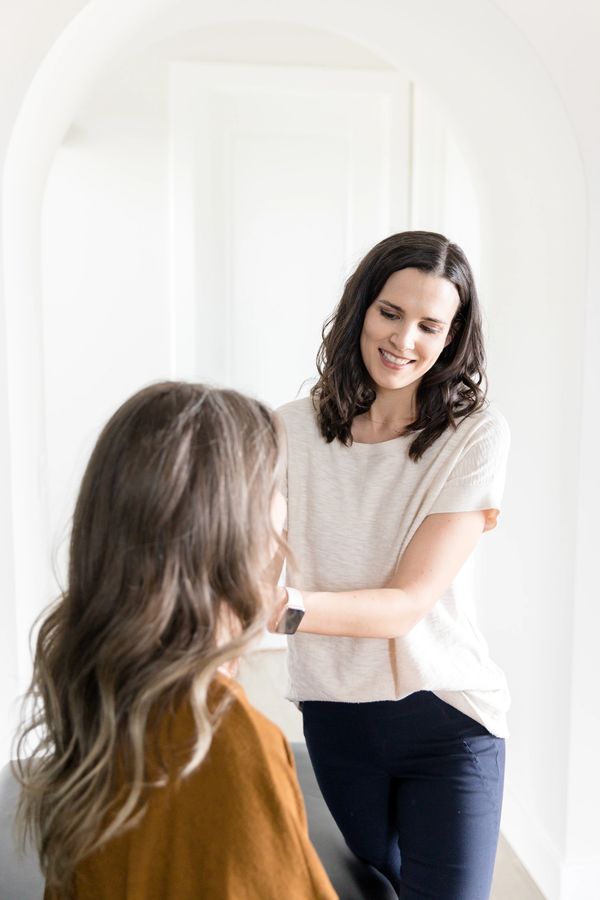 Dr. Annie is examining a patient on a treatment table.