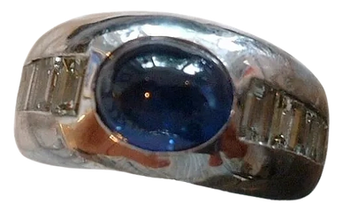An 18kt White Gold Ring
set with Diamonds 
& a Blue Sapphire Cabochon