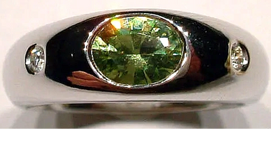 An 18kt White Gold Ring
set with a Malaya Garnet
& Diamonds