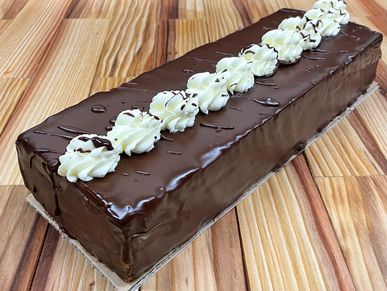 fancy chocolate cake with ganache and vanilla frosting