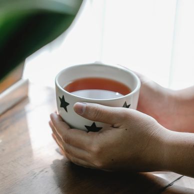hands holding a cup of tea