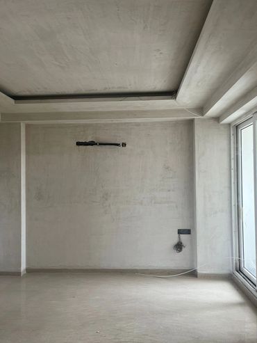 Empty unfinished room with bare walls and exposed wiring.
