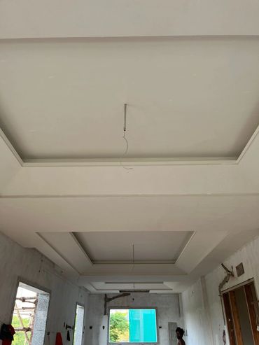 Unfinished room with recessed ceiling and hanging wires.