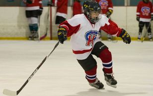 Minor hockey players receiving coaching instruction at Christensen Hockey school