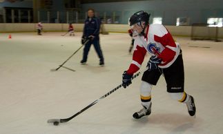 Minor hockey players receiving coaching instruction at Christensen Hockey school