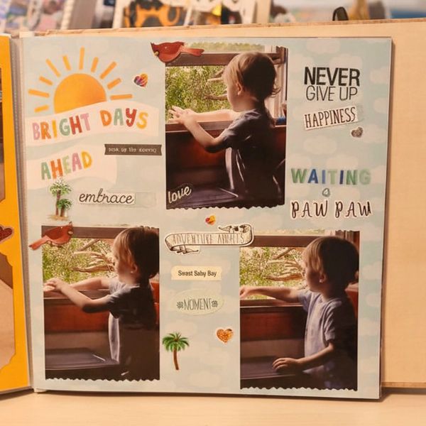 A scrapbook page with a child looking out a window and positive words.
