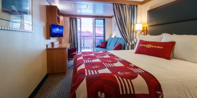 Cozy hotel room with a large bed and balcony.