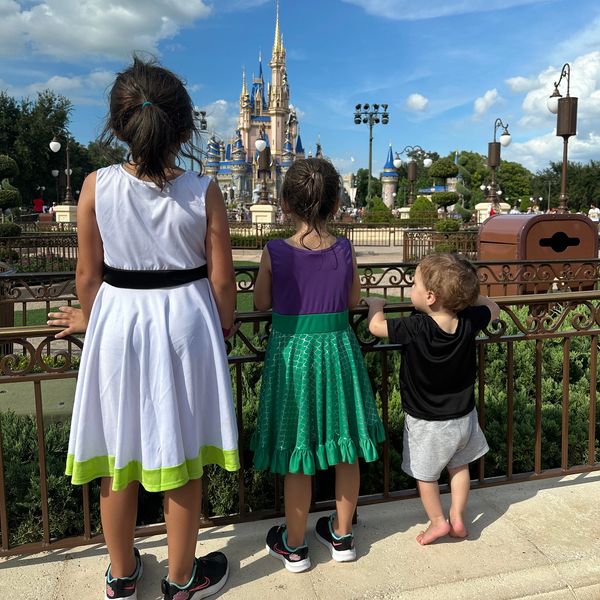 Three children looking at a Disney castle.