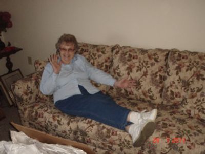 a man sitting on top of a couch in a living room