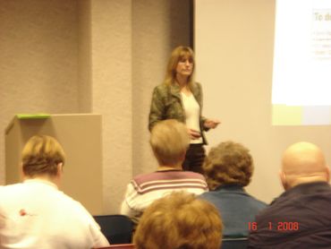 a woman standing in front of a group of people