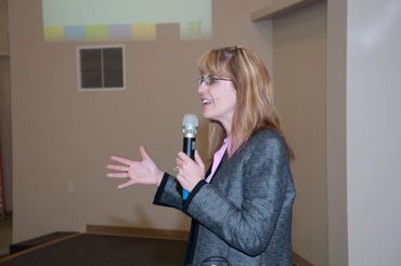 a woman standing in front of a microphone