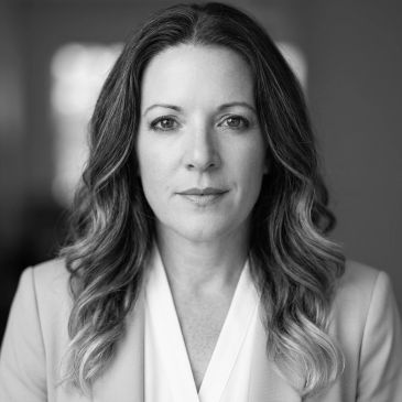 Black and white portrait of a woman with wavy hair.