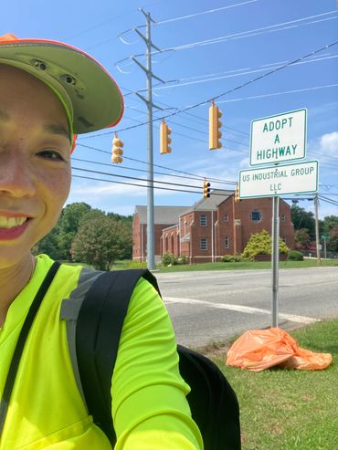 Smiling in front of sign