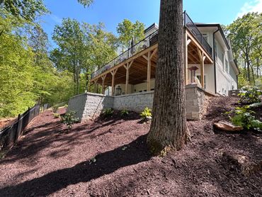 Tiered retaining walls and hillside mulch installation at a home in Flowery Branch, GA