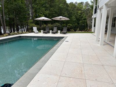 Poolside patio install limestone tile – Signature Lawn Service landscape project in North Georgia.