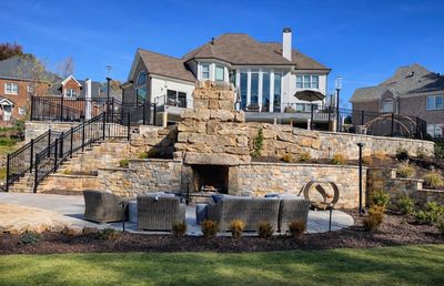 Patio and firepit built into retaining wall in Buford, Ga. Work done by Signature Lawn Service.