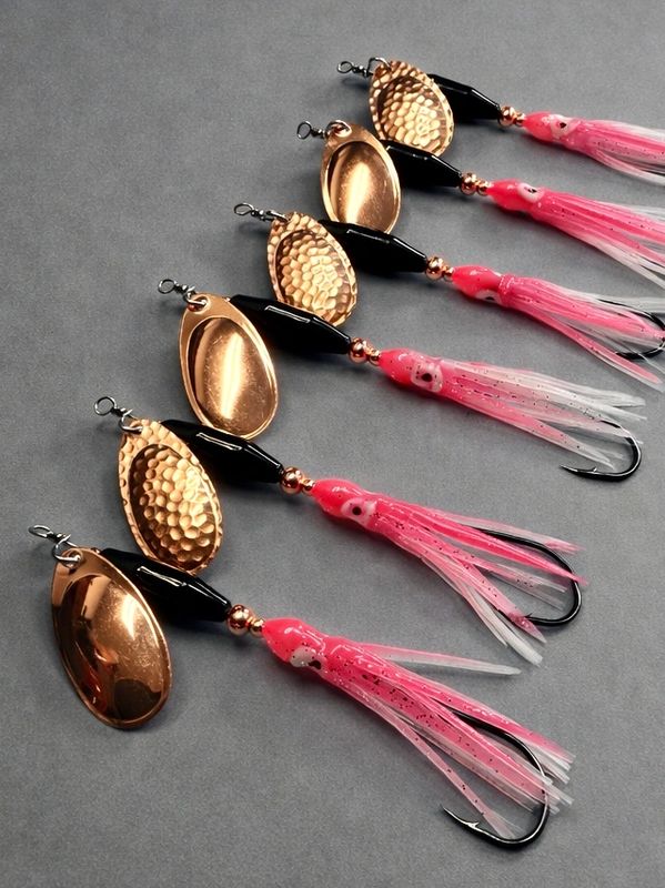 Six custom Captain Homers lures with pink skirts and metal spinner blades on a gray background.