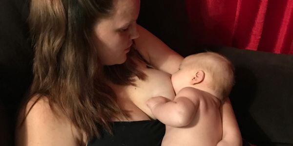 Mom breastfeeding after tongue tie release with the help Milk Masters Lactation Consultants
